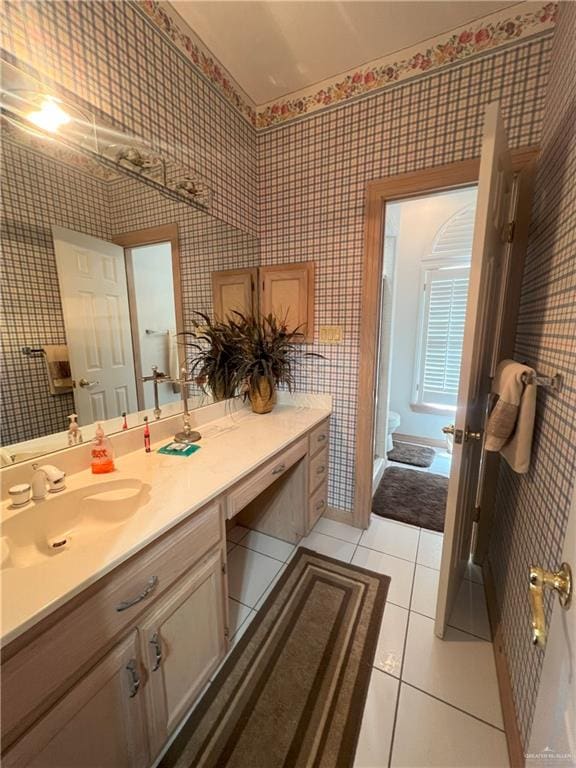 bathroom featuring tile patterned floors, vanity, and toilet