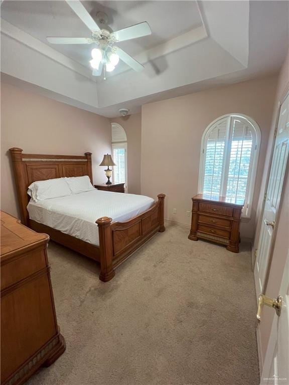 bedroom featuring light colored carpet, multiple windows, and ceiling fan