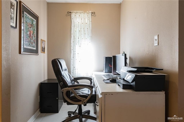 home office featuring baseboards and a textured wall