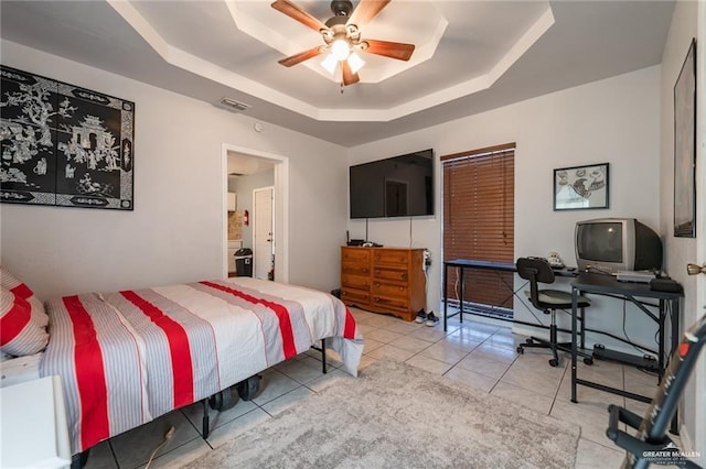 bedroom with visible vents, ceiling fan, light tile patterned flooring, and a tray ceiling
