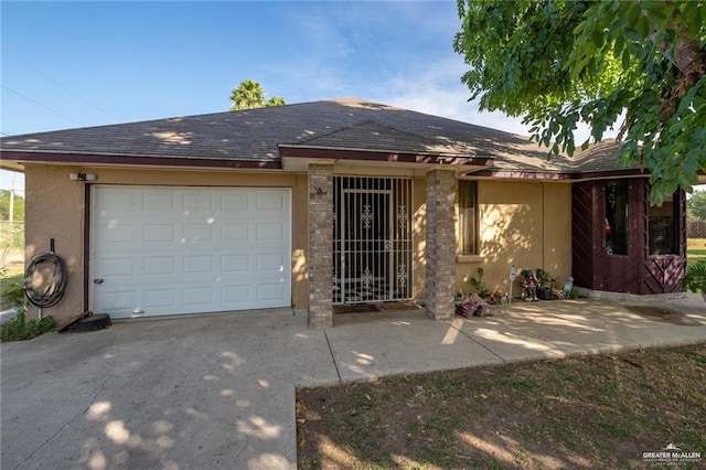 single story home featuring stucco siding, concrete driveway, a shingled roof, and a garage