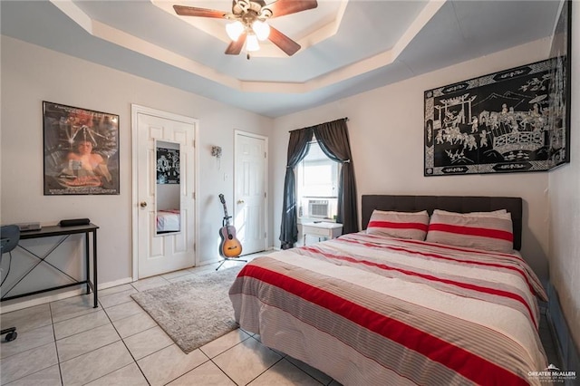 bedroom with light tile patterned floors, a raised ceiling, and ceiling fan