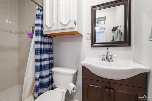 bathroom with vanity, toilet, and a shower stall