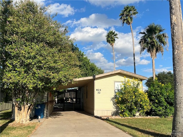 view of side of home with a carport