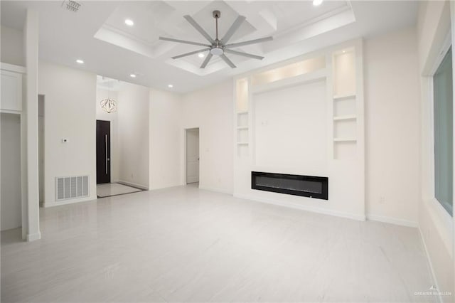 unfurnished living room with a high ceiling, built in features, ceiling fan, and coffered ceiling