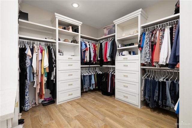 spacious closet with light hardwood / wood-style floors