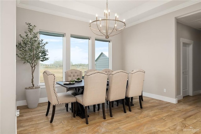 dining room with light wood-type flooring, an inviting chandelier, and crown molding