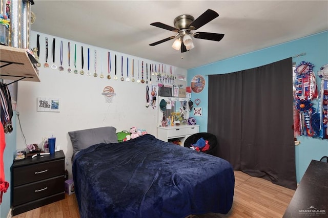 bedroom featuring light wood-type flooring and ceiling fan