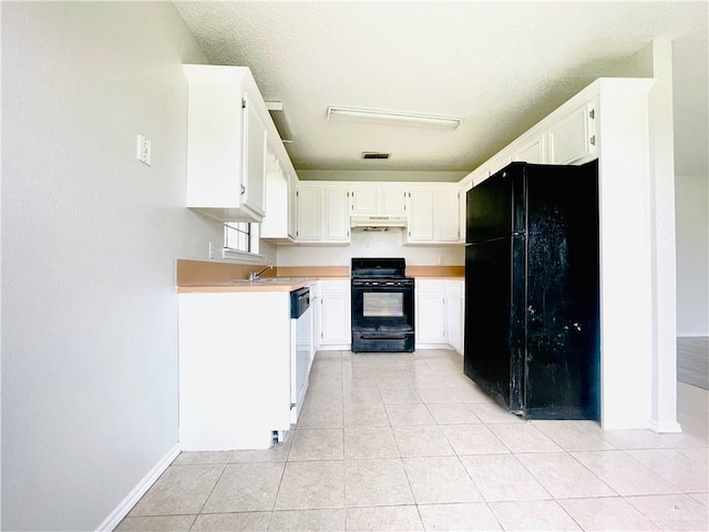 kitchen featuring black appliances, white cabinets, sink, light tile patterned floors, and a textured ceiling