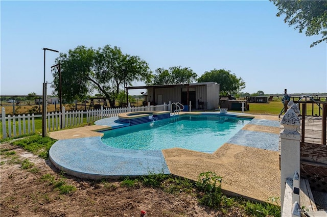 view of swimming pool featuring an in ground hot tub