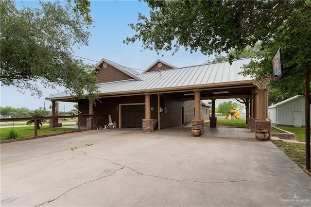 view of front of home with a garage and a carport