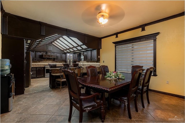 dining space featuring ceiling fan, ornamental molding, light tile patterned floors, and lofted ceiling