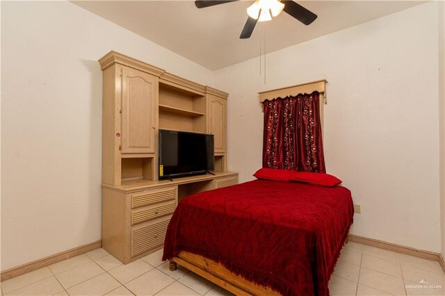 tiled bedroom featuring ceiling fan