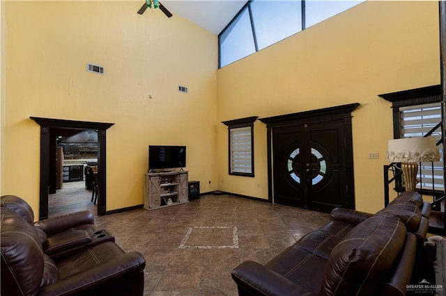 living room featuring ceiling fan and high vaulted ceiling