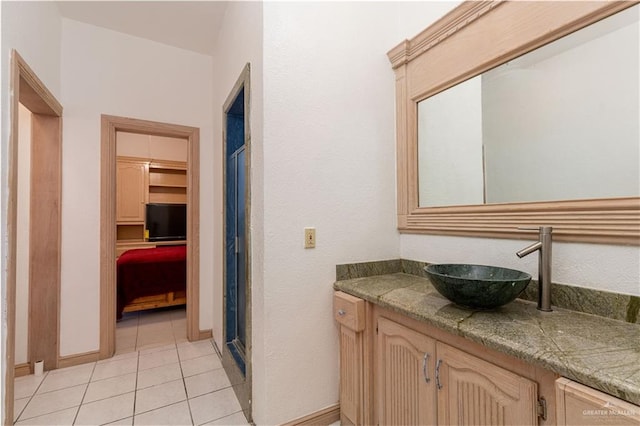 bathroom featuring tile patterned floors, vanity, and a shower with door