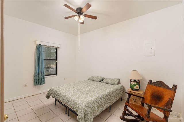 tiled bedroom featuring ceiling fan