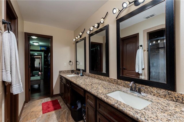 bathroom featuring vanity and a shower with shower door