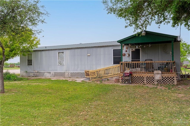 rear view of house featuring a lawn