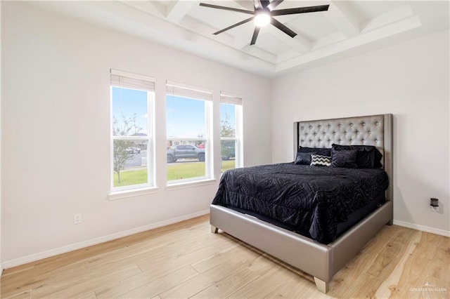 bedroom featuring beam ceiling, light hardwood / wood-style floors, and ceiling fan