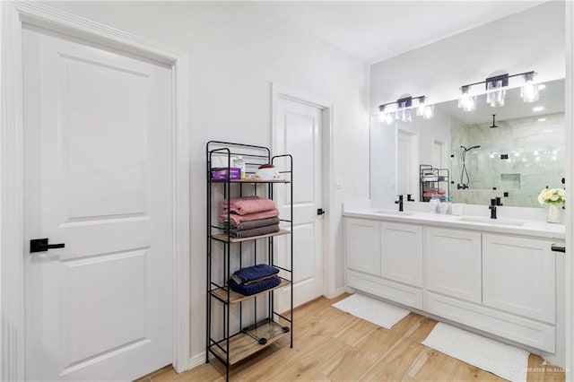 bathroom featuring hardwood / wood-style floors, vanity, and an enclosed shower