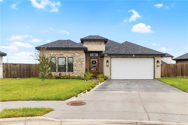 view of front of property featuring a front yard and a garage