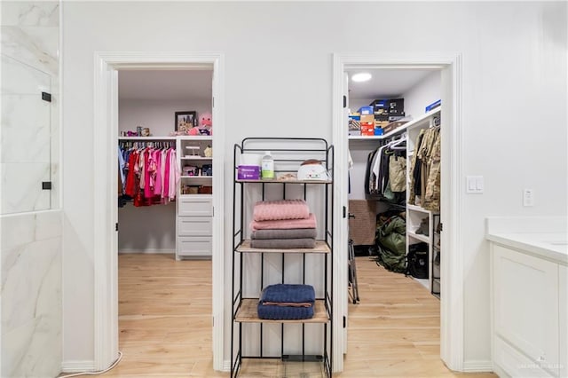 walk in closet featuring light hardwood / wood-style floors