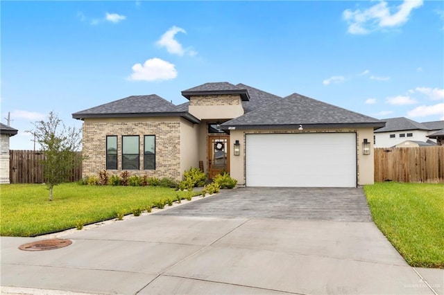 prairie-style home with a garage and a front lawn