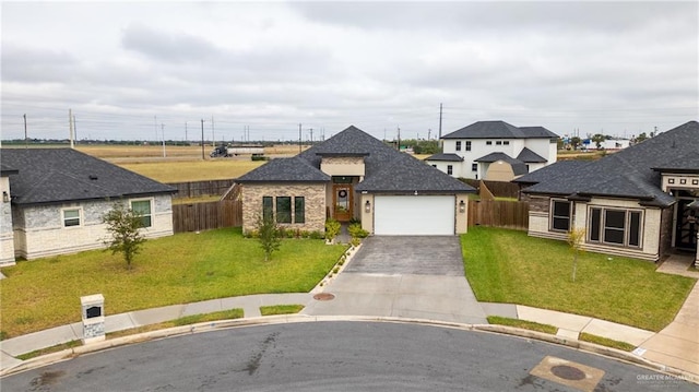 view of front of house featuring a garage and a front lawn