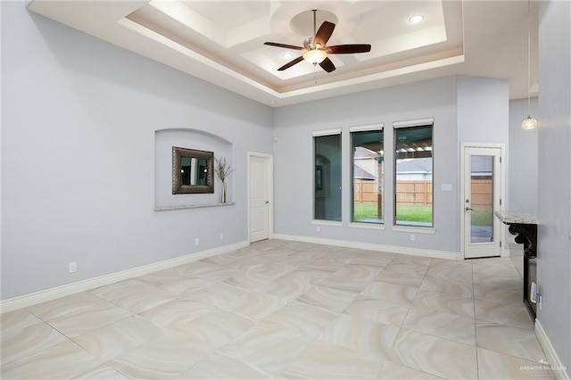 5105 August Ct, Edinburg, TX 78539 - spare room with baseboards, a ceiling fan, and a tray ceiling