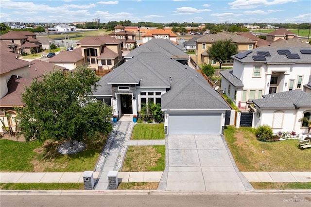 5105 August Ct, Edinburg, TX 78539 - view of front of property with a front lawn, driveway, a residential view, and a garage