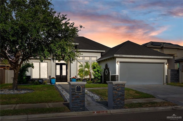 5105 August Ct, Edinburg, TX 78539 - view of front of home with concrete driveway, a front lawn, french doors, an attached garage, and stucco siding