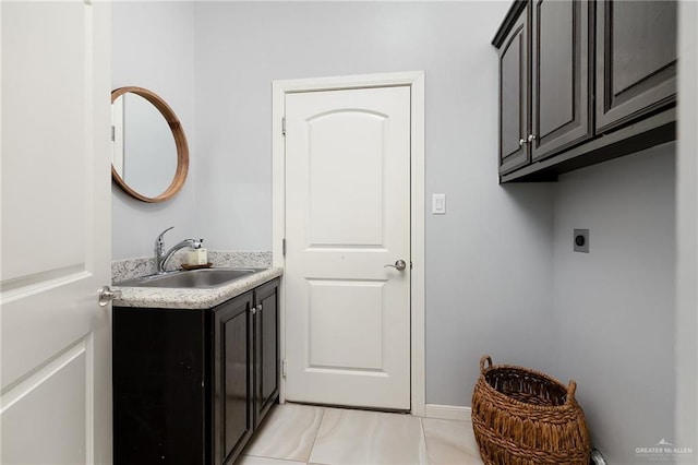 5105 August Ct, Edinburg, TX 78539 - washroom with electric dryer hookup, cabinet space, a sink, and light tile patterned flooring