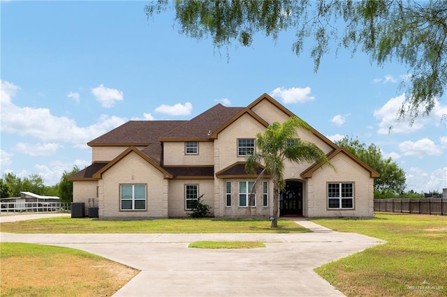 view of front facade with a front lawn and central AC unit