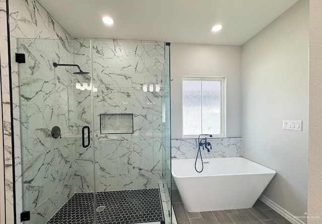 bathroom featuring shower with separate bathtub