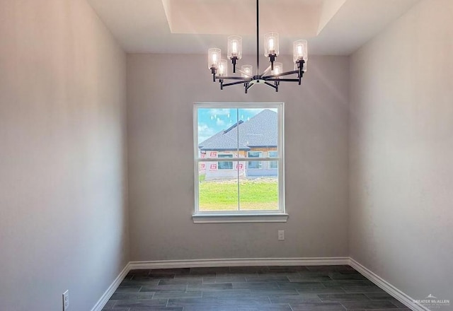 unfurnished dining area featuring dark wood-type flooring and a notable chandelier