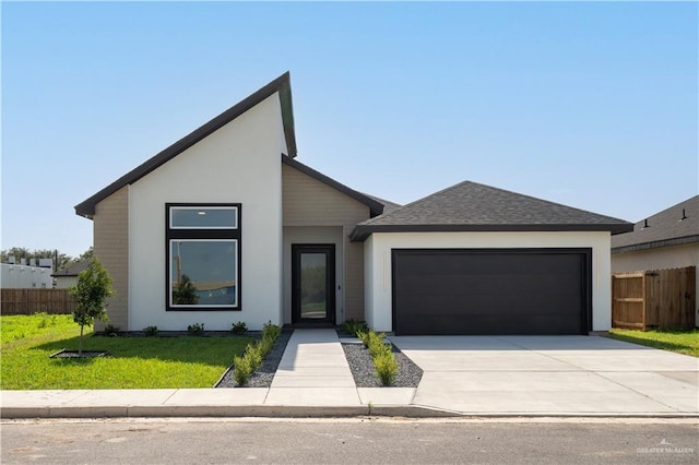 view of front facade featuring a garage and a front lawn