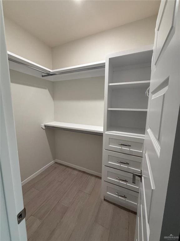 spacious closet featuring light hardwood / wood-style floors