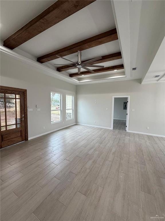 empty room featuring beam ceiling, ceiling fan, and light hardwood / wood-style flooring