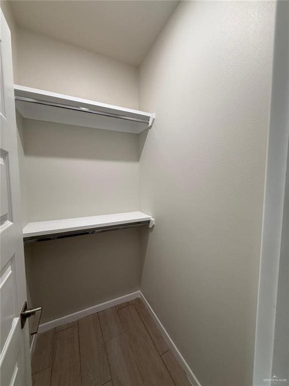 walk in closet featuring wood-type flooring