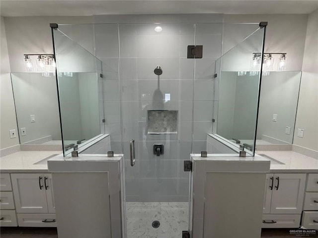 bathroom with walk in shower and vanity