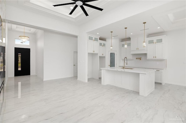 900 N Trinity St, Edinburg, TX 78541 - kitchen with white cabinetry, glass insert cabinets, hanging light fixtures, a towering ceiling, and recessed lighting