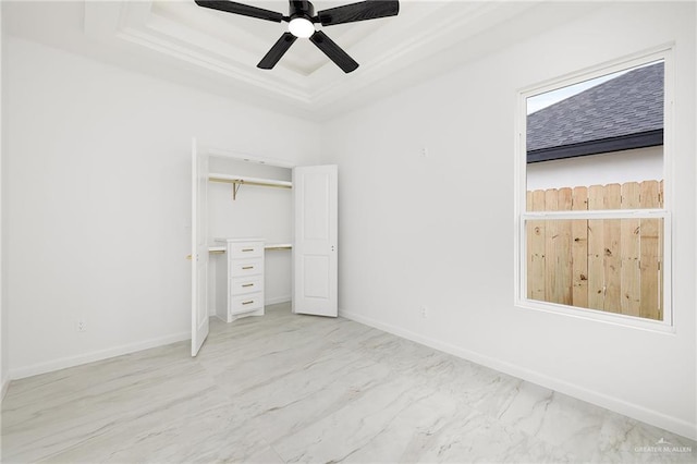 900 N Trinity St, Edinburg, TX 78541 - unfurnished bedroom with a raised ceiling, a closet, ceiling fan, and marble finish floors
