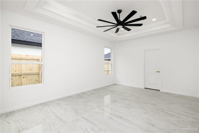 900 N Trinity St, Edinburg, TX 78541 - spare room with a tray ceiling, marble look tiles, a ceiling fan, and recessed lighting