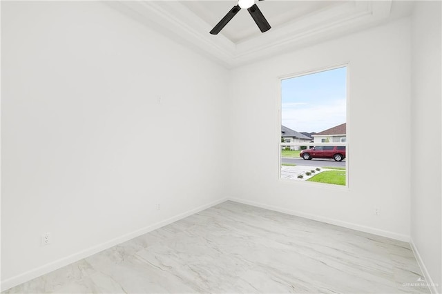 900 N Trinity St, Edinburg, TX 78541 - unfurnished room with a tray ceiling, marble finish floors, and a ceiling fan