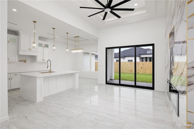 900 N Trinity St, Edinburg, TX 78541 - kitchen with light marble finish flooring, white cabinetry, glass insert cabinets, light countertops, and recessed lighting