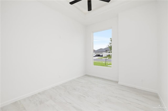 900 N Trinity St, Edinburg, TX 78541 - empty room featuring light marble finish flooring, ceiling fan, and a raised ceiling