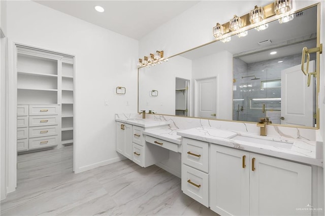 900 N Trinity St, Edinburg, TX 78541 - bathroom featuring double vanity, a shower stall, a spacious closet, and marble look tiles