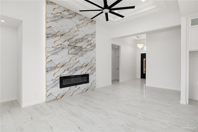 900 N Trinity St, Edinburg, TX 78541 - unfurnished living room featuring a fireplace, an accent wall, recessed lighting, ceiling fan, and marble finish floors