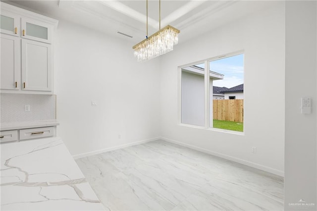 900 N Trinity St, Edinburg, TX 78541 - unfurnished dining area featuring light marble finish flooring and a chandelier