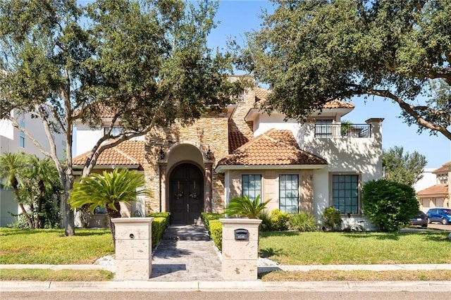 view of front of property featuring a front lawn and french doors